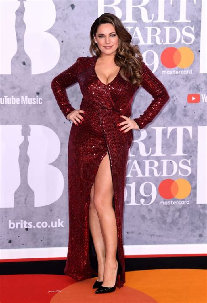 Kelly Brook flaunts her curves in a pretty playsuit as she enjoys the